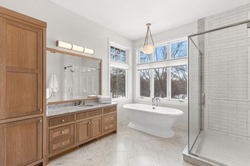 Primary bathroom with Carrera marble and heated floors.
