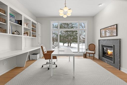 Main floor office space with new fire place surround and built-in enameled shelving.