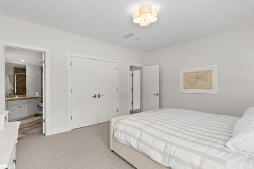 lower level bedroom with walk in closet and bathroom ensuite.