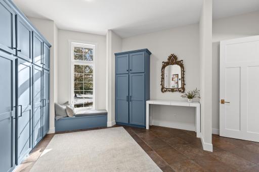Back hall /mud room entrance area with enameled cabinetry.