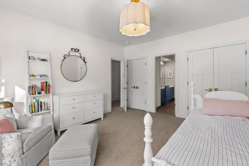 lower level bedroom with ensuite bathroom and walk- in closet.