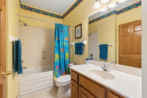 Main Level Full 2nd Bath with a Jetted Tub, Tile Flooring, a Large Vanity, Lots of Counterspace, One Linen Closet Inside and One Just Outside in the Hallway.