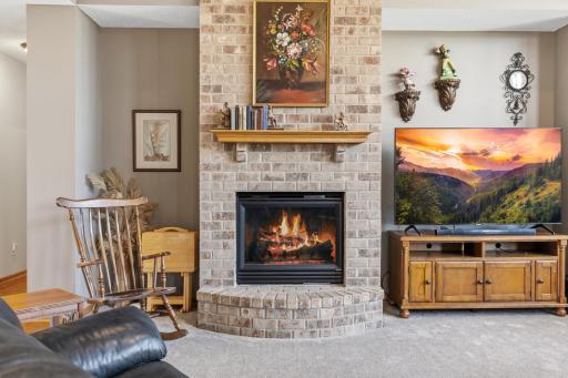 High Ceilings Showcase the Gas Fireplace with Oak Mantle and Inviting Hearth, and Lots of Space for Built Ins or Furnishings.