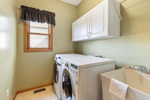 The Main Level Laundry with LG Washer, Samsung Dryer and Wash Basin is Just off the Kitchen and Just in from the 3-Car Garage.