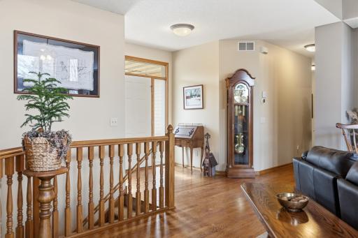 Oak Flooring Extends from the Garage, Through the Kitchen and Past the Living Room, Past the Staircase with its Beautiful Oak Spindles and Railing, Through the Entry with Transom and Sidelight Windows...