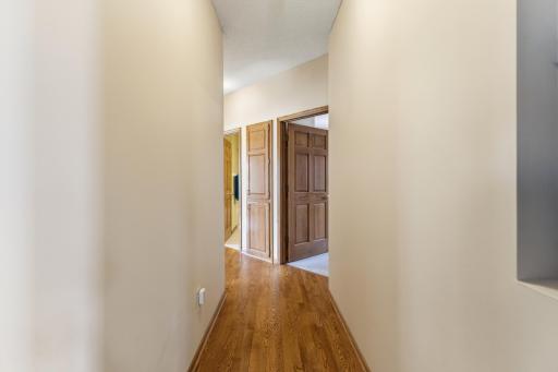 ...and to the Owners Suite at Right, a Full Bath and 2 Additional Main Level Bedrooms. Each with the Solid 6-Panel Oak Doors Found Throughout the Main Level.