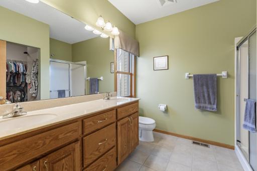 Spacious Owners 3/4 Bath with Tile Flooring, Private Elevated Backyard Views, Double Bowl Vanity and Lots of Cabinet Space.