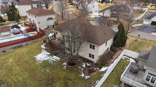 This View Shows the Neighboring Privacy Fences in the Back Yard, with the Left Side Atop Landscape Stones. Add Short Sections to Connect to Both Sides of the Home and a Run Beneath the Pines to Make it Fully Fenced.