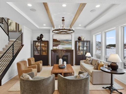 Spacious great room anchored by expansive windows and refined finishes