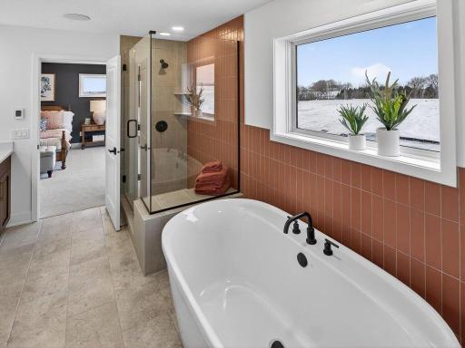 . Luxurious primary bath featuring spa-inspired finishes and fixtures.
