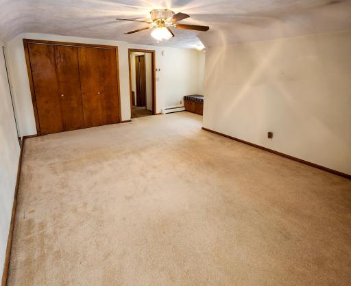 Upper Floor Bedroom with Large Closet with light. Amazing Knee Wall Attic Storage with 2 Access Doors in this room.jpg