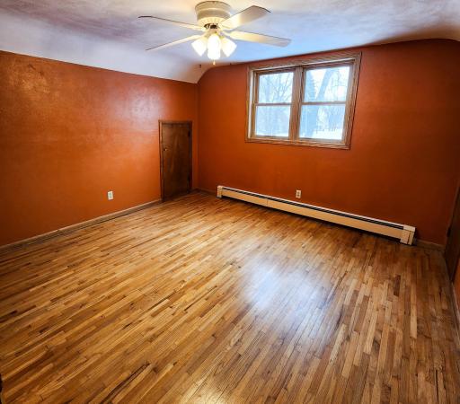 2nd of 2 Upper Floor Bedrooms. This one has orginal hardwood floors, a large closet and 2 access doors to the knee wall attic space. .jpg