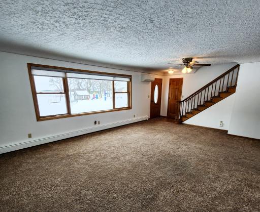 I'm not sure what my favorite part of this room is - the open staircase, the large picture window or that unique ceiling. I just love this room.jpg