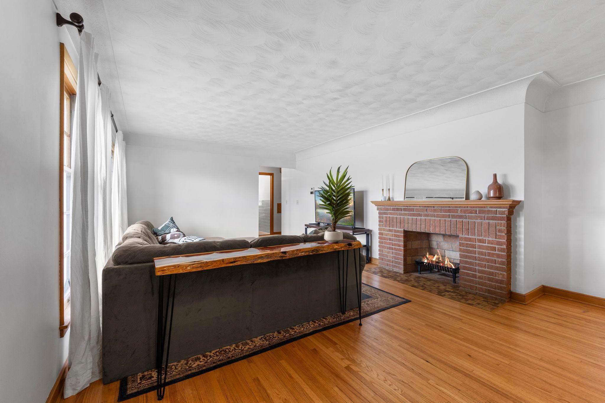 Original wood flooring refinished on main level. Cove ceiling with swirl texture and knockdown ceiling around cove trim enhancing the architecture.