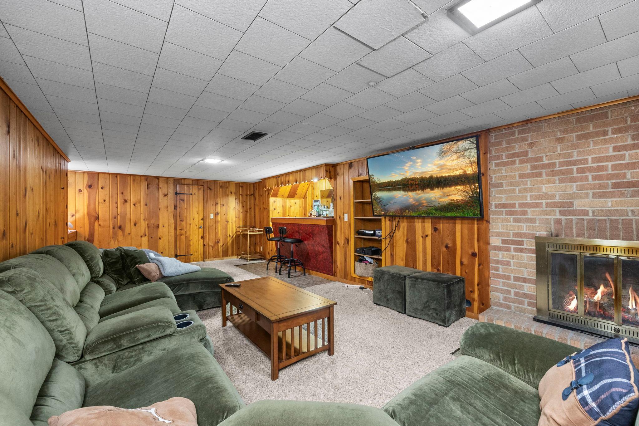 Discretely hidden bathroom door within cedar wall paneling to the 3/4 bathroom!