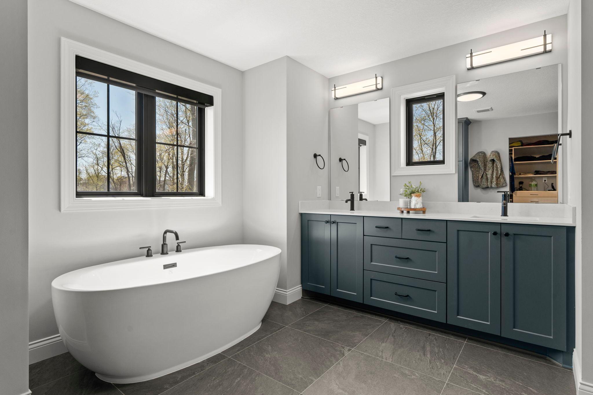 Owner's Bath with separate tile shower and walk-in closet with built-ins