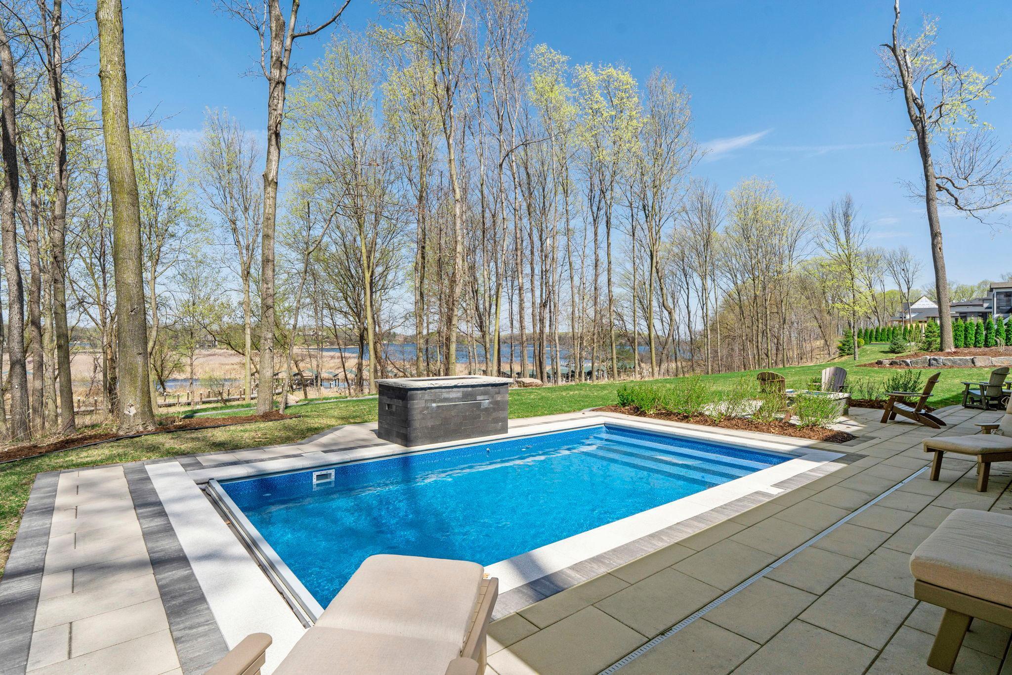 Saltwater pool with fireplace and waterfall feature