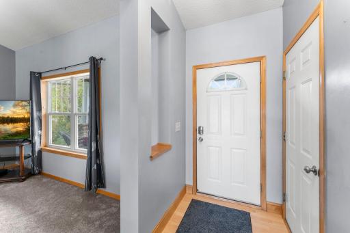 Entryway opens to the living room and access to the garage.