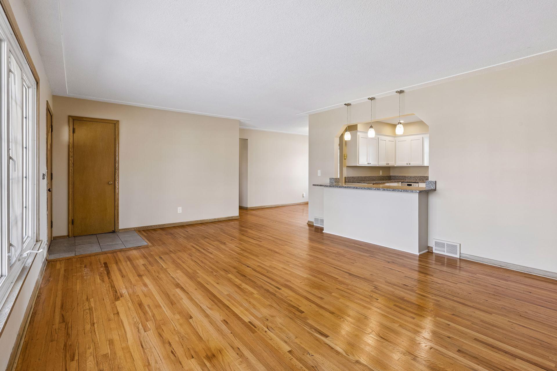 The main floor boasts gleaming hardwood floors and the kitchen has been opened up into the living room.