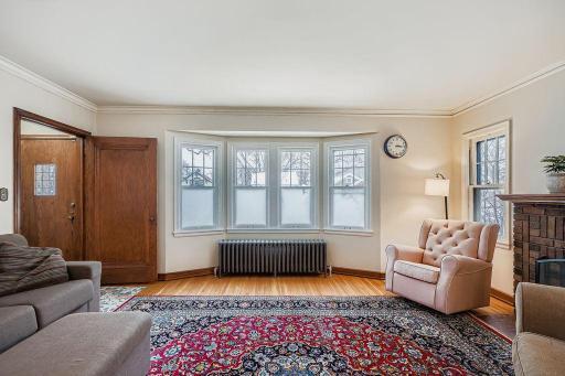 Classic hardwood floors throughout home and beautiful bay window in living room