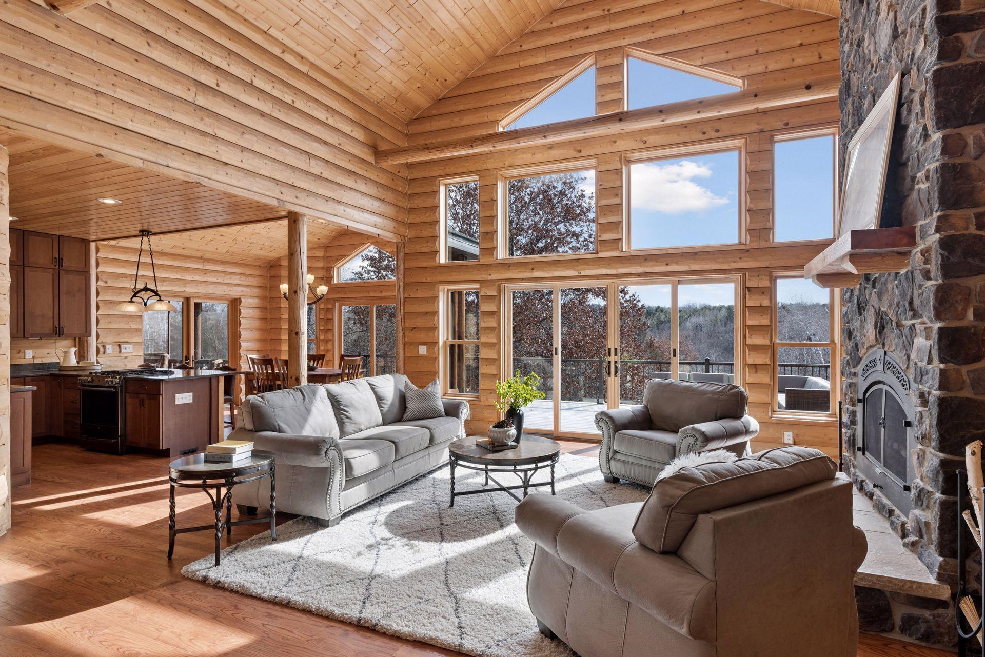 Bright and airy great room flowing into kitchen and dining with panoramic wooded views