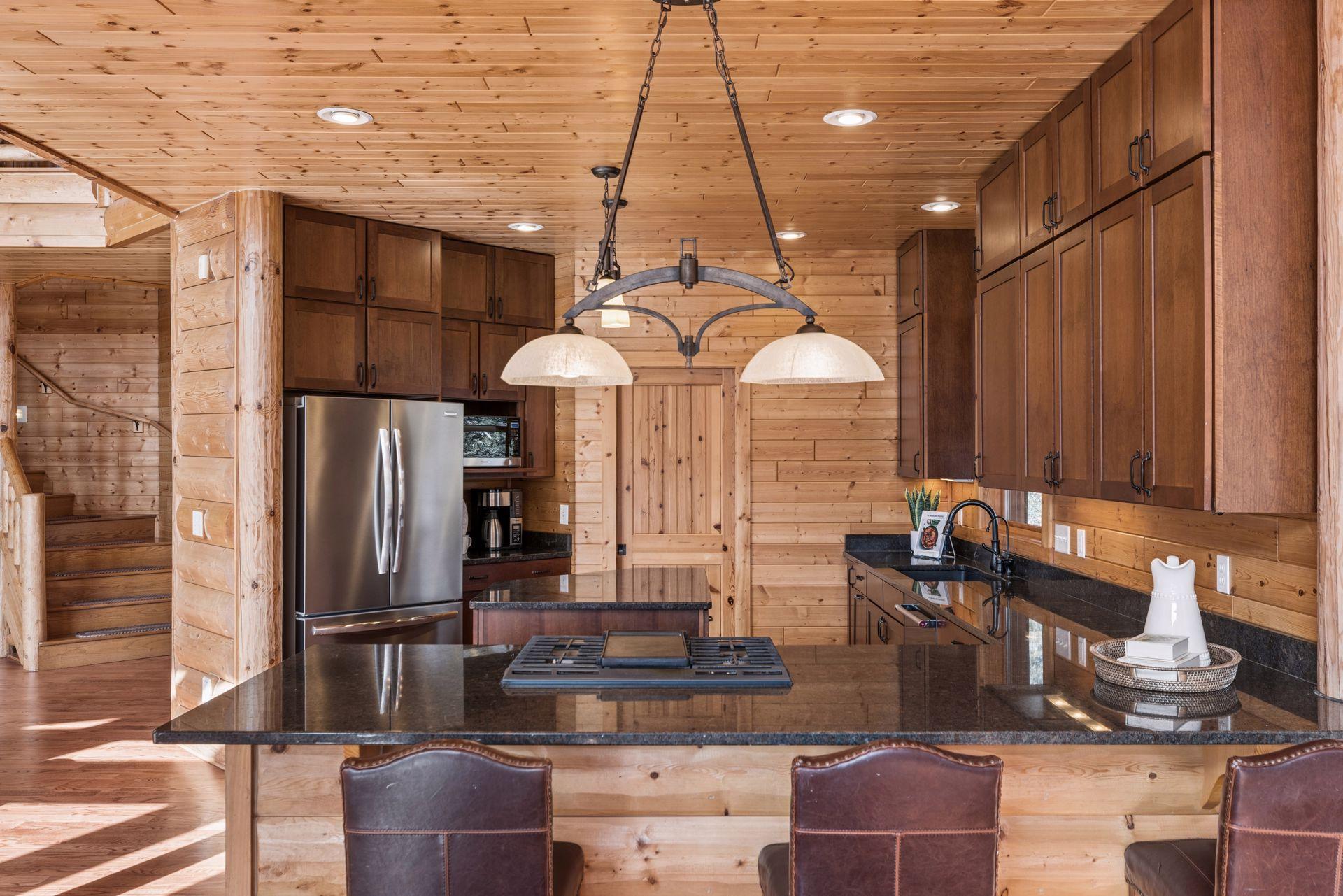 Kitchen with breakfast bar seating, pendant lighting, and stainless steel appliances