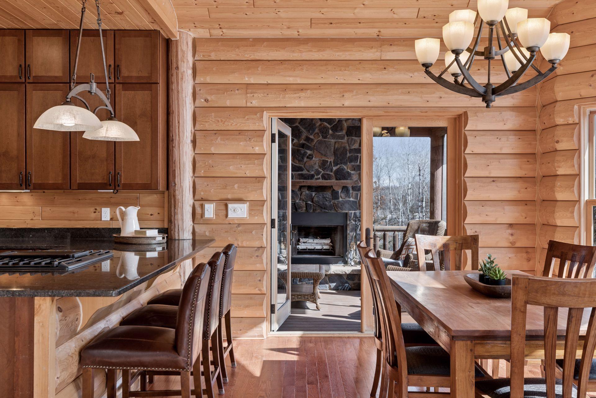 Bright dining area with large windows and access to the deck and screened porch