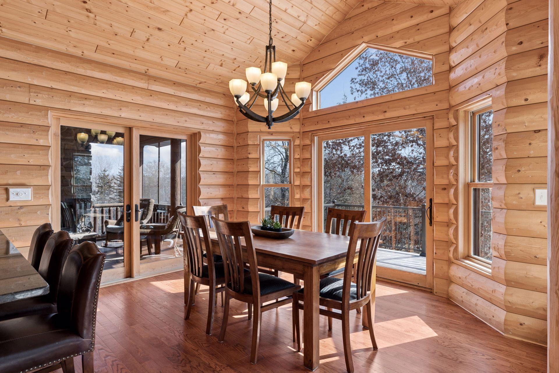 Bright dining area with large windows and access to the deck and screened porch