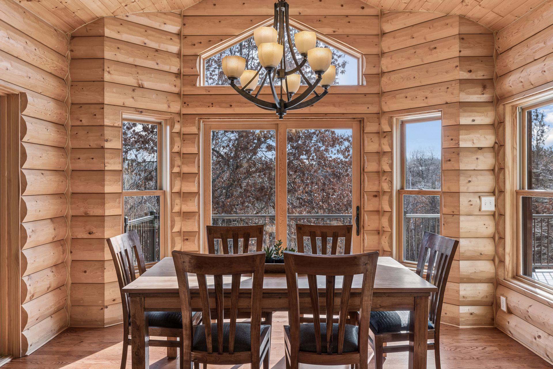 Bright dining area with large windows and access to the deck and screened porch