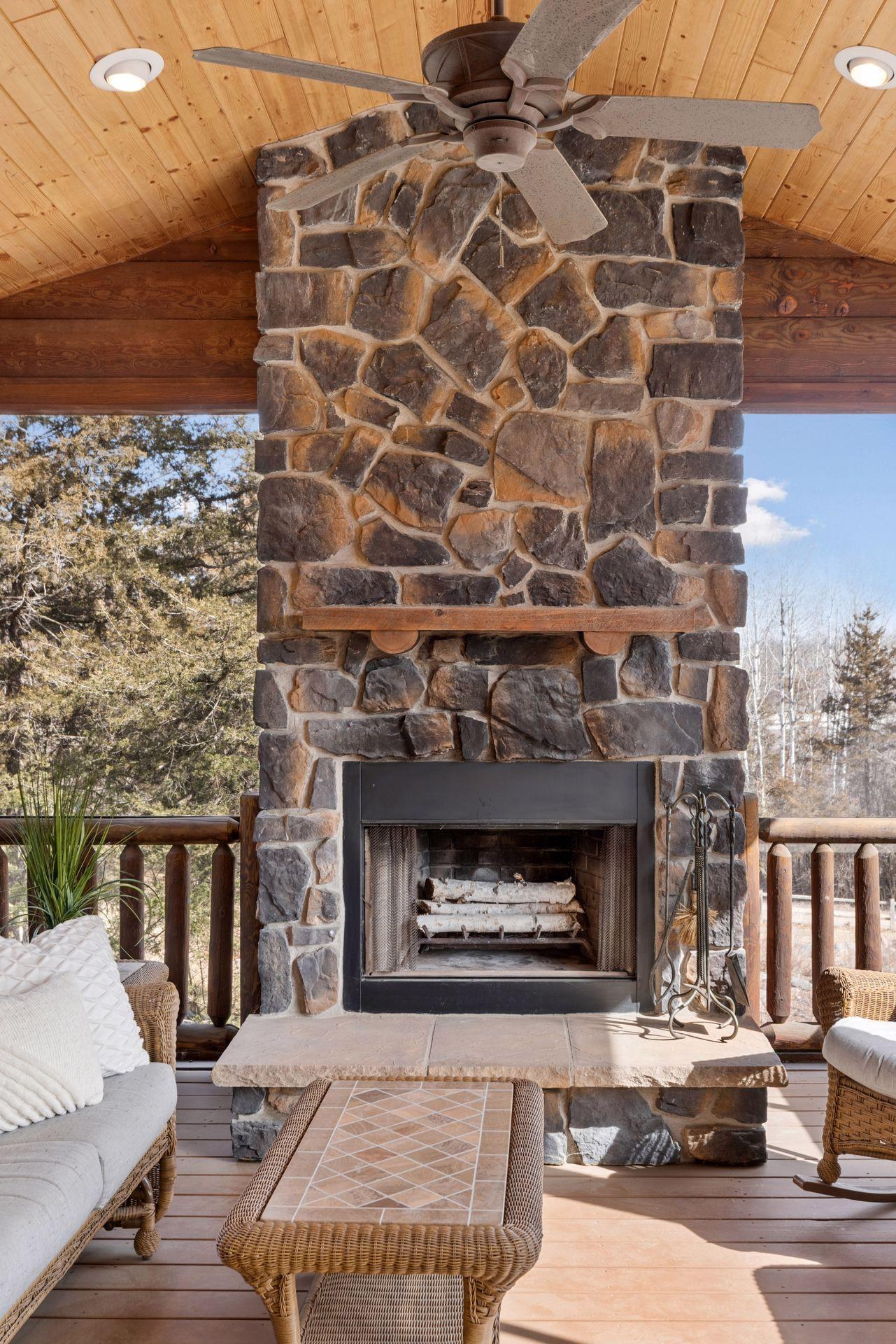 The wood burning stone fireplace in the screen porch is a showstopper from both the interior and exterior views!