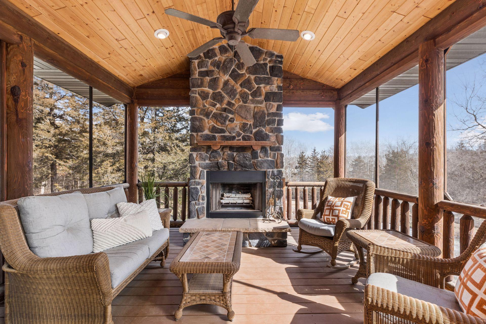 Screened porch with stunning stone fireplace perfect for 3-season+ enjoyment