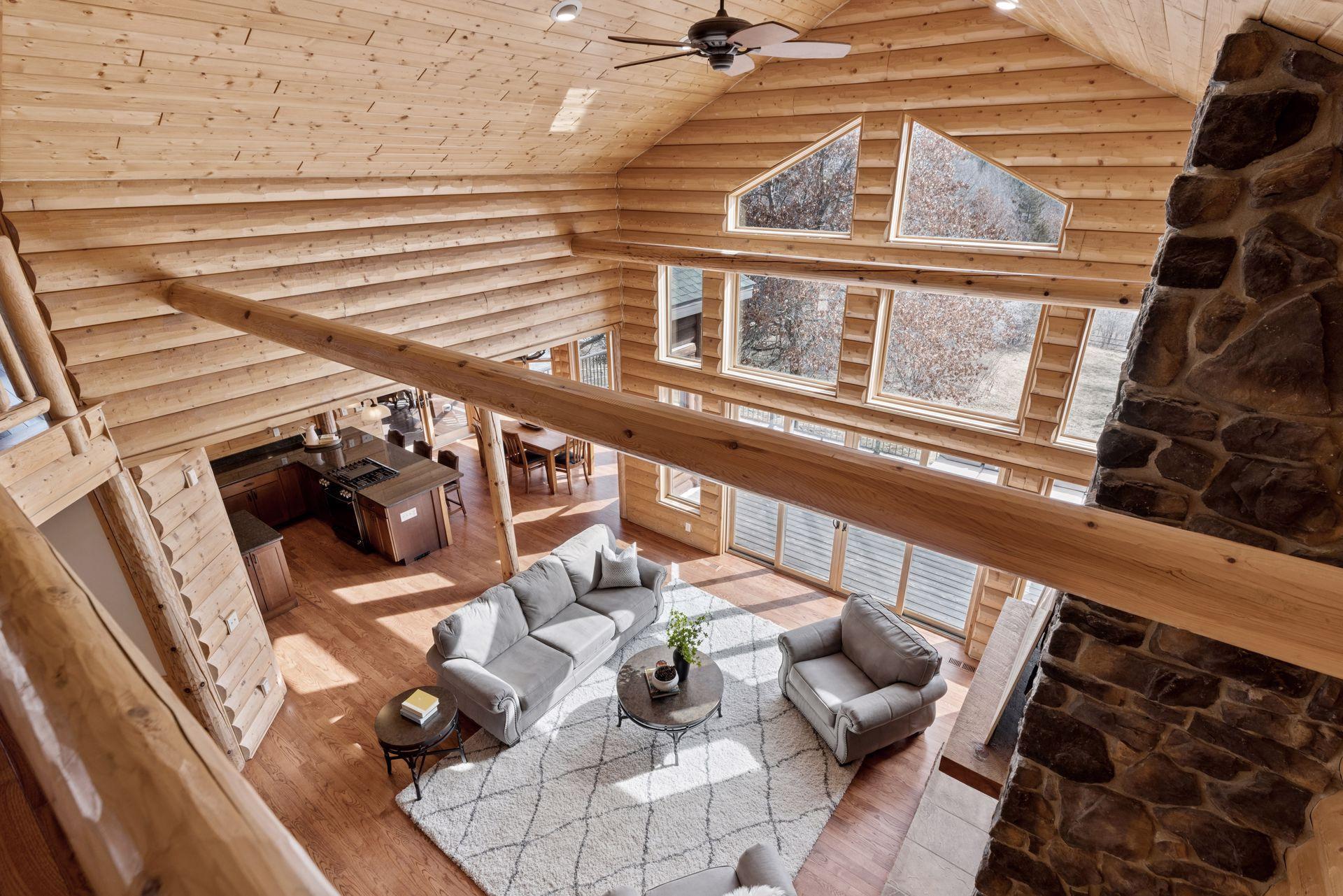 Dramatic overlook to the great room showcasing soaring ceilings and wall of windows