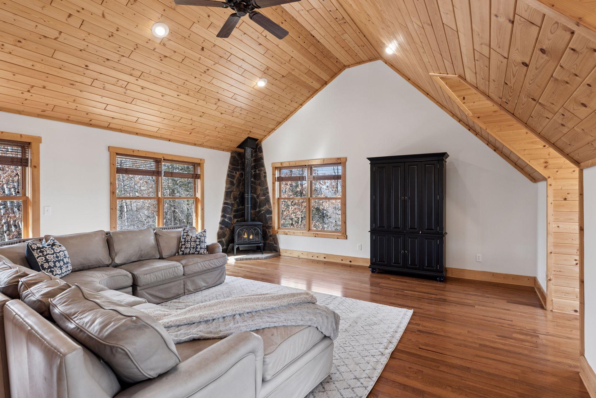 Cozy upper-level bonus room with wood stove and vaulted ceilings