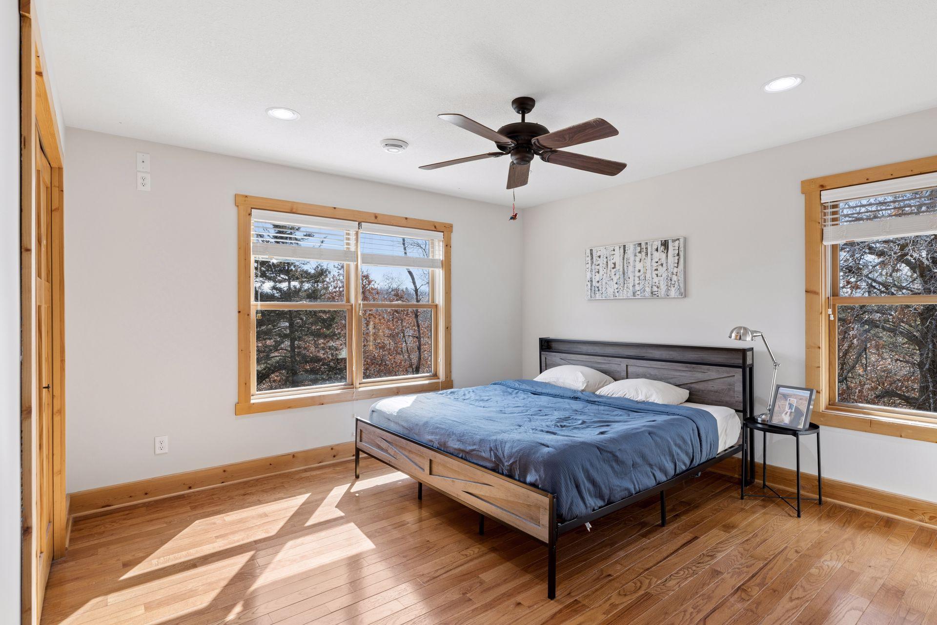 Bright secondary bedroom with large windows and natural light