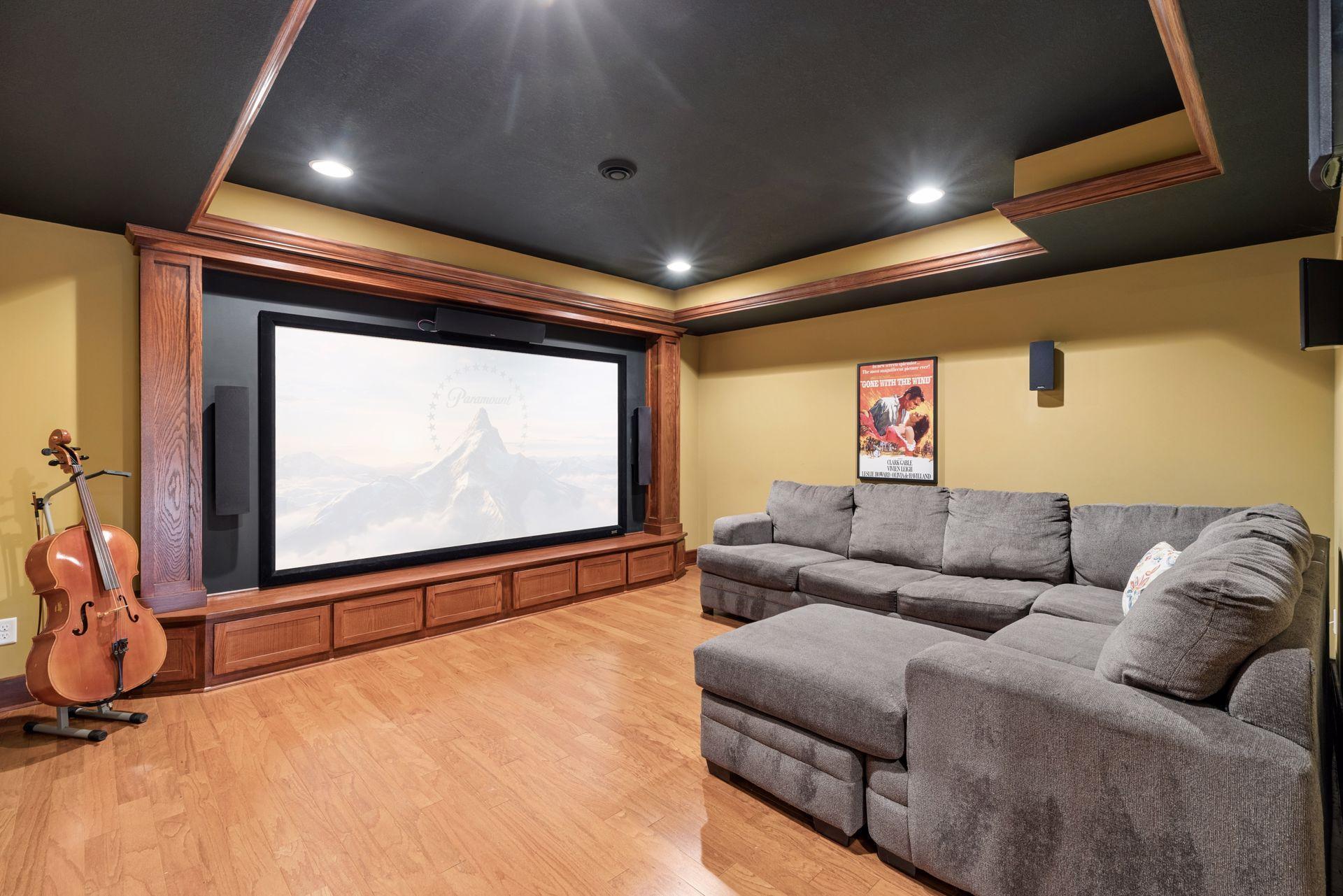 Dedicated theater/media room with built-in screen, surround sound, and custom woodwork, perfect for movies or music