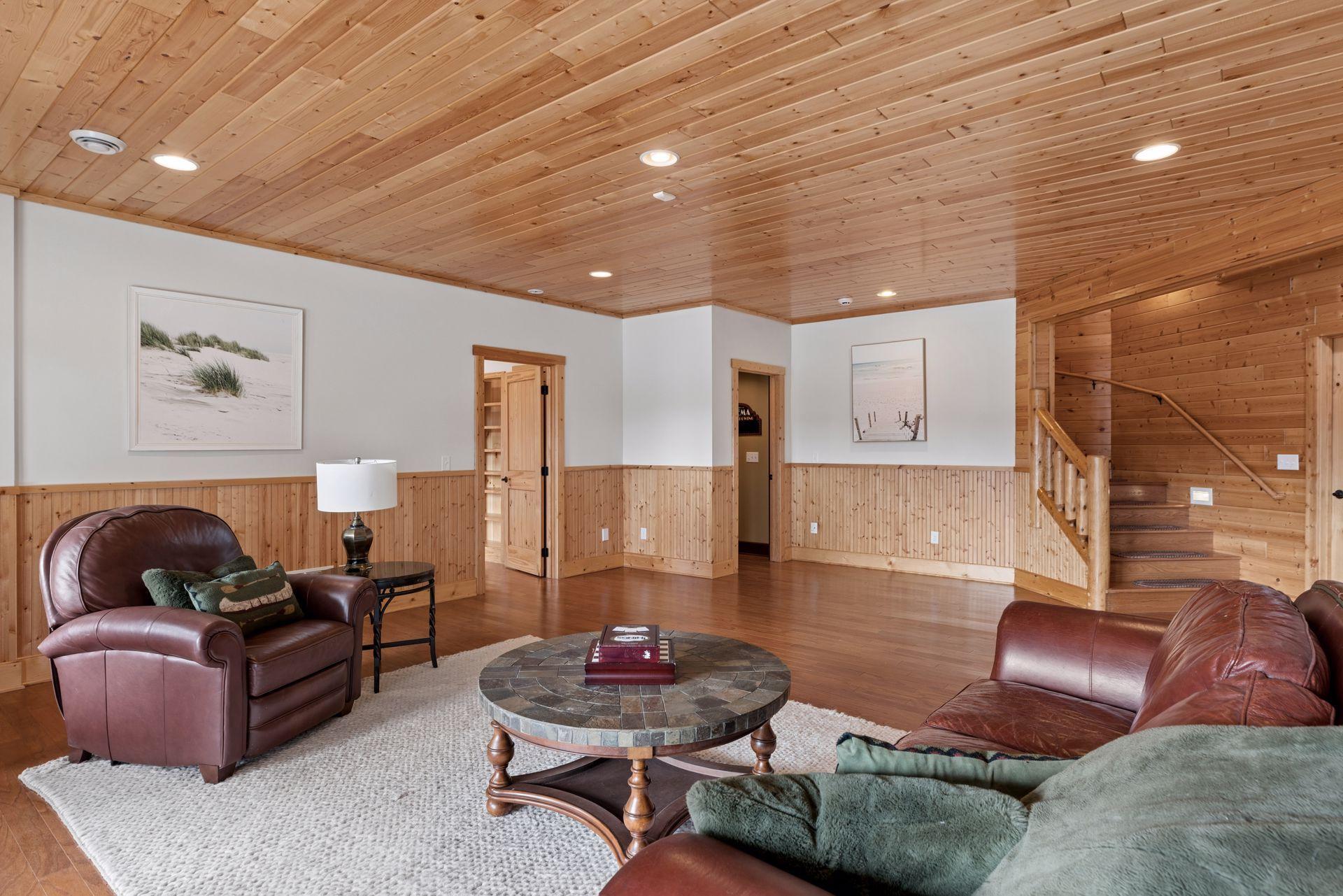 Expansive lower-level gathering space with rustic detailing and flexible layout options