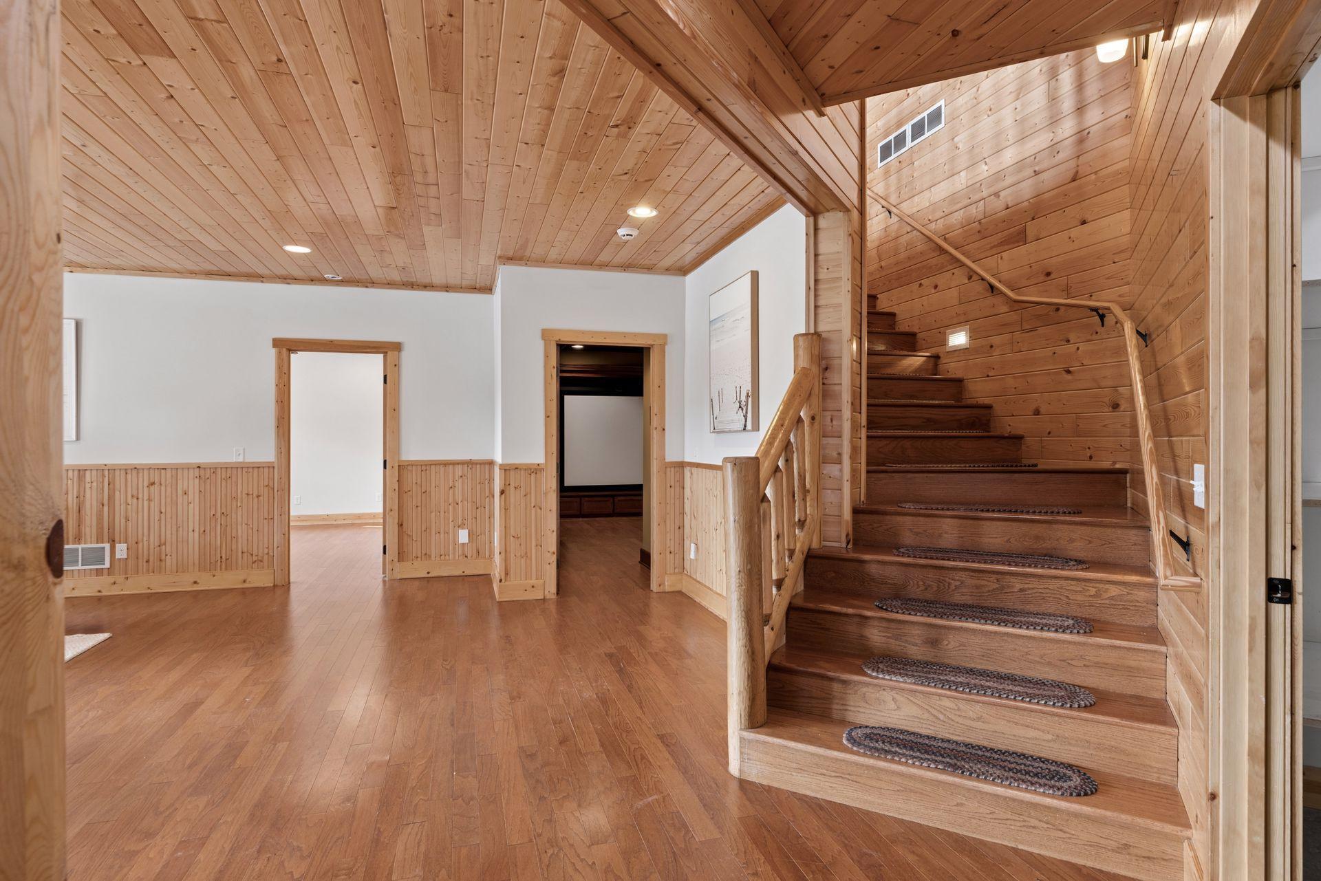 Handcrafted wood staircase connecting levels with striking log railing detail
