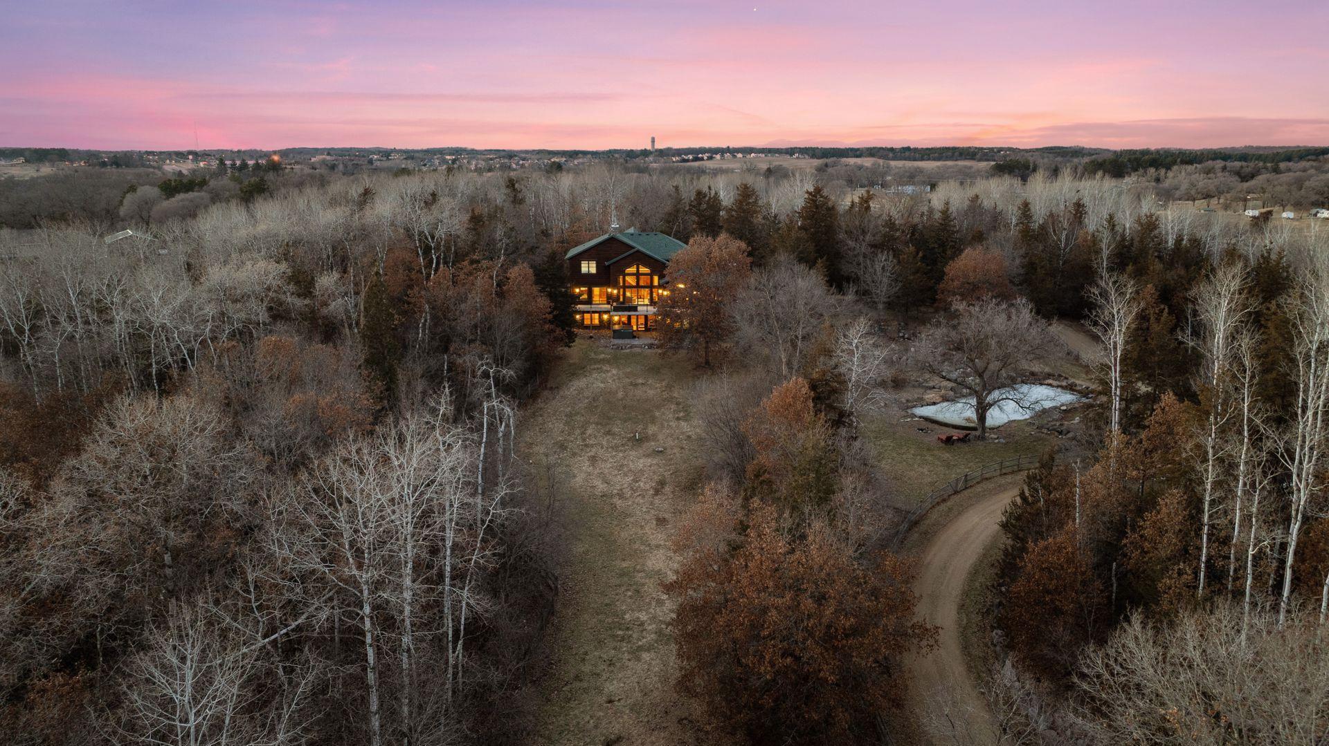 Aerial perspective featuring private pond and beautiful, winding driveway approach