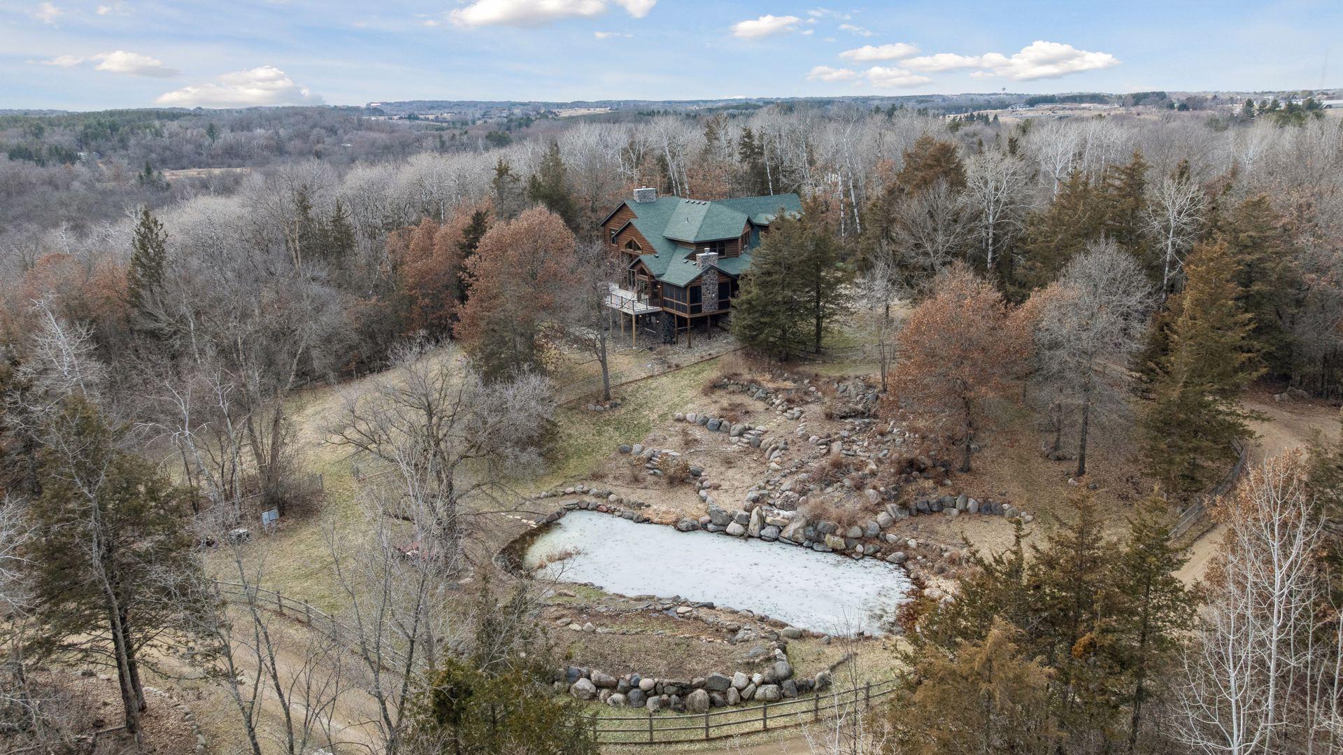 Aerial perspective featuring private pond and beautiful, winding driveway approach