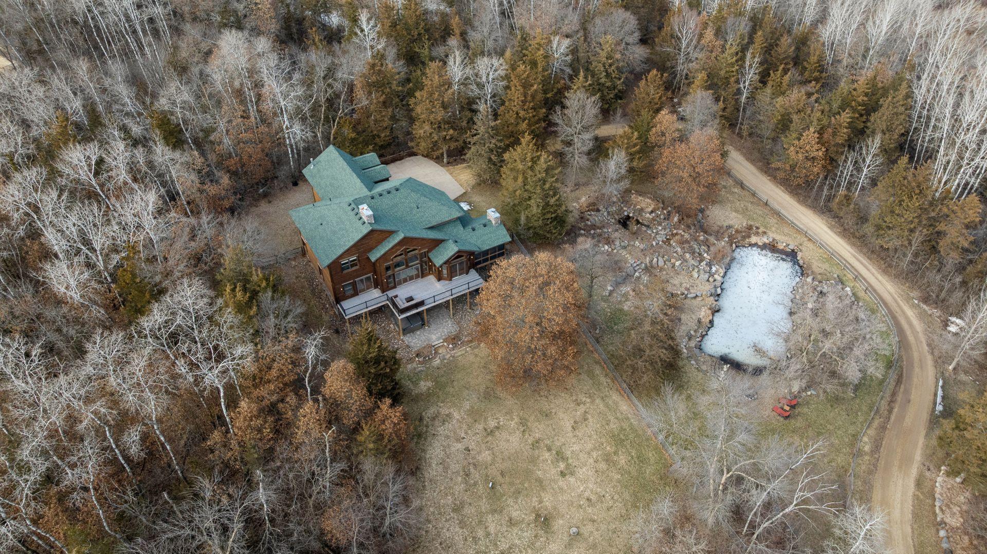 Aerial perspective featuring private pond and beautiful, winding driveway approach