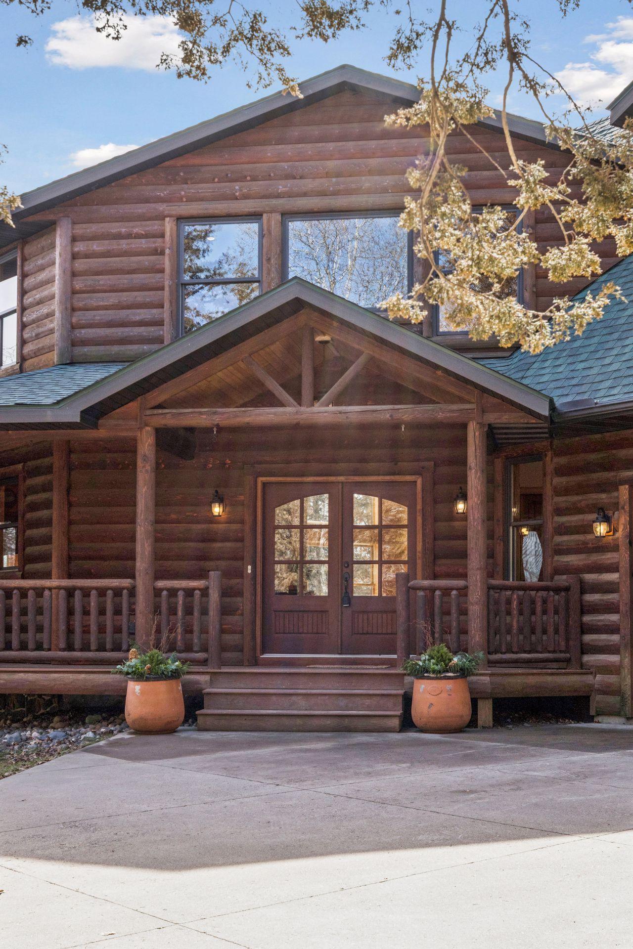 Craftsman-inspired front entry with timber framing and double doors creating a grand first impression