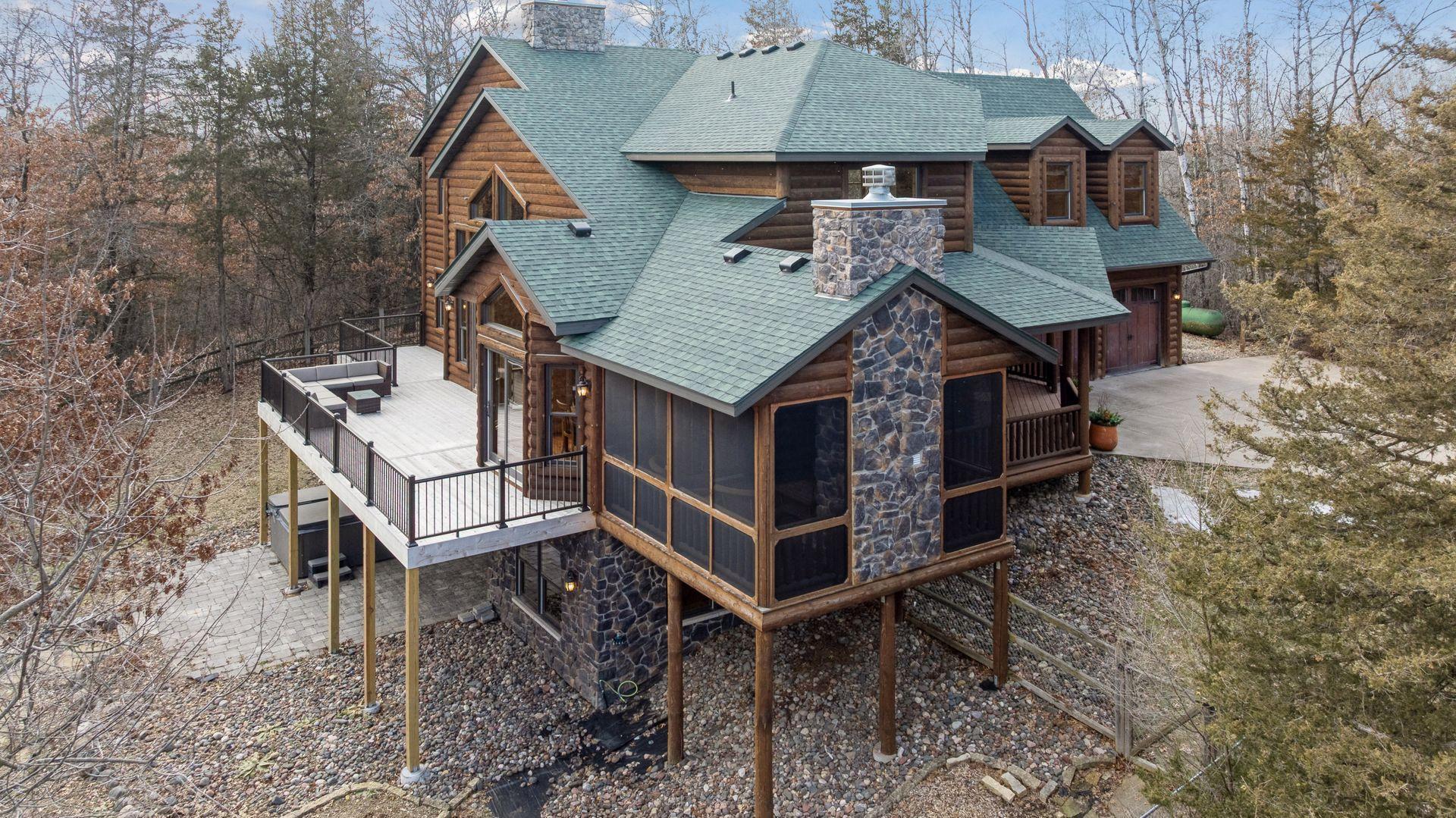 Screened porch with stone fireplace, perfect for enjoying the outdoors in comfort
