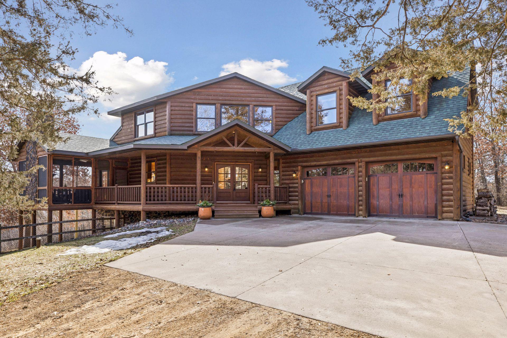 Classic log-style exterior with2-car garage and spacious parking pad for guests