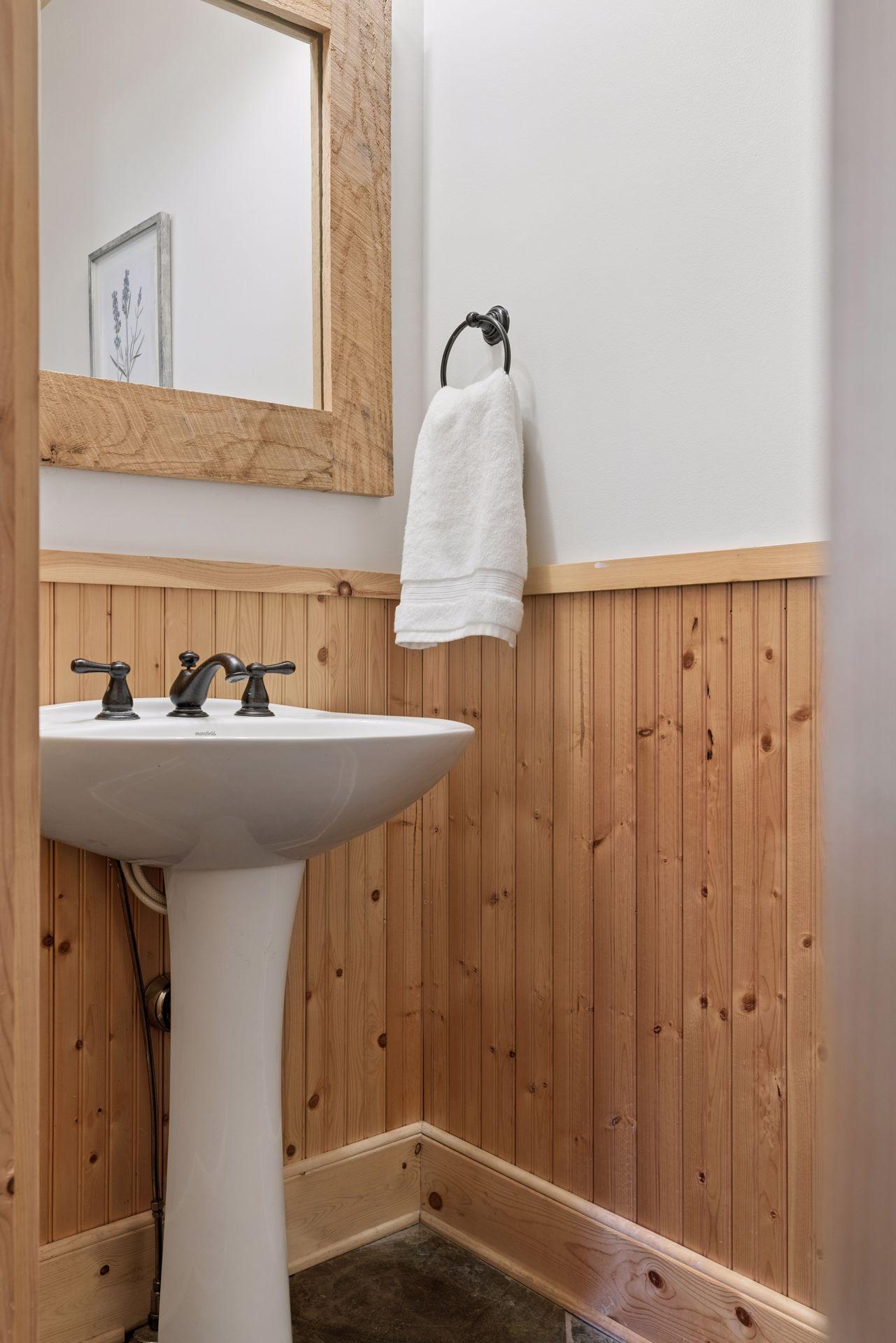 The main level guest bathroom is conveniently located near the entryway.