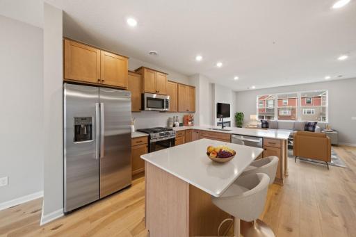 Offering timeless finishes that blend an elevated feel with functionality. The L-shaped kitchen with island and adjacent dining area make a perfect space for both everyday meals and entertaining.