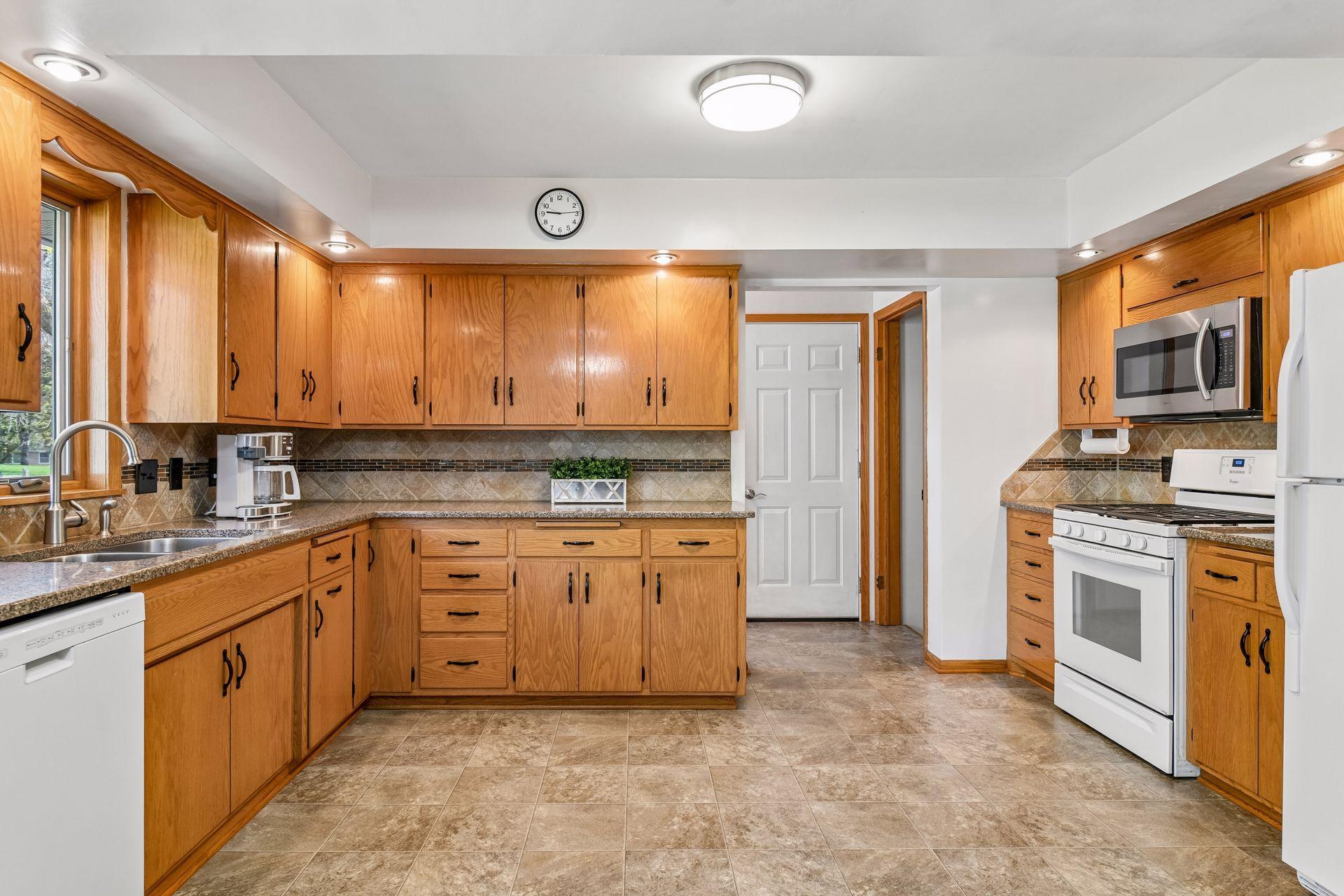This home has generous counter space, classic wood cabinetry and ample storage.