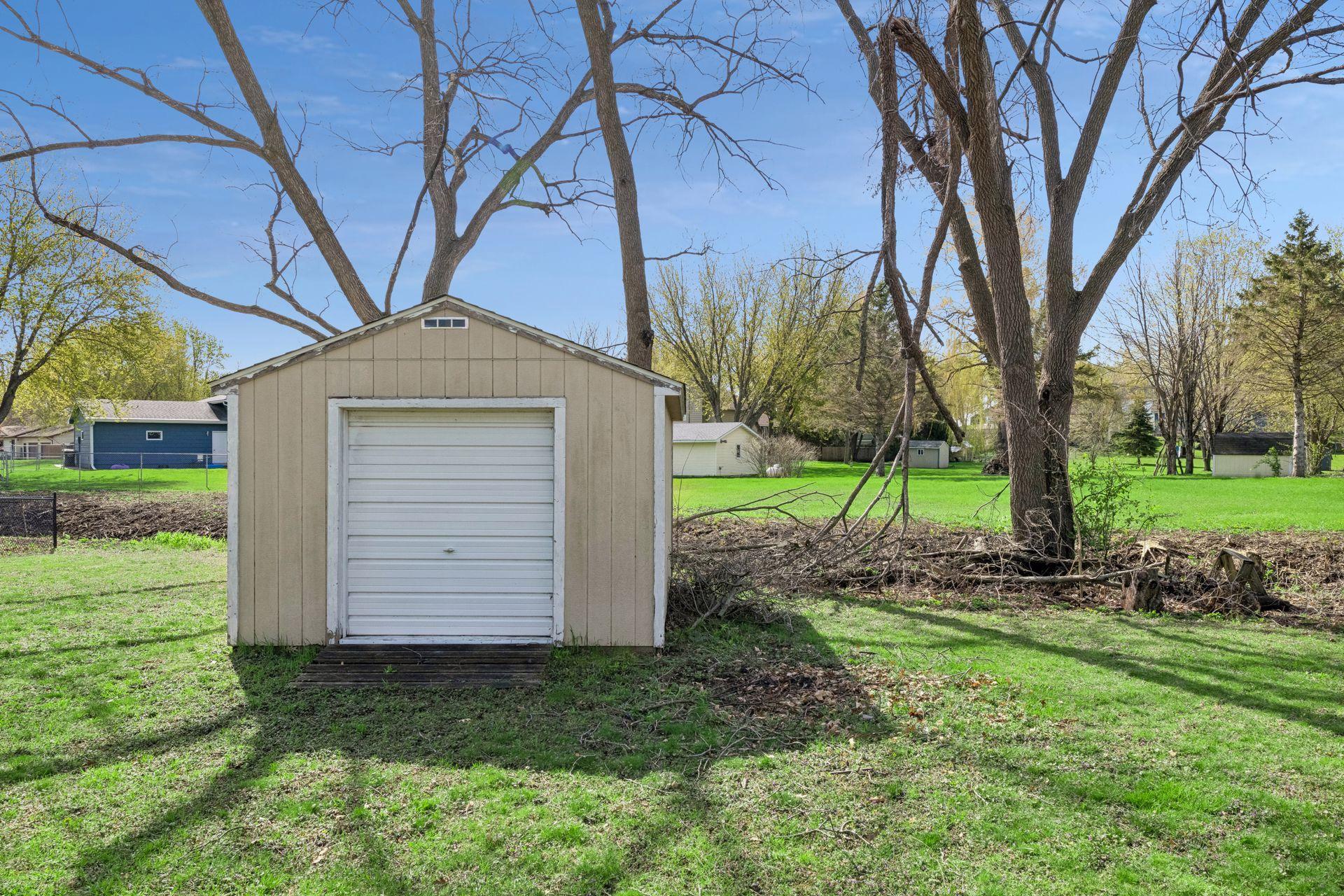 Bonus detached outbuilding with an overhead door. Tools, mowers, kayaks, and seasonal gear get a home of their own instead of taking over the garage.