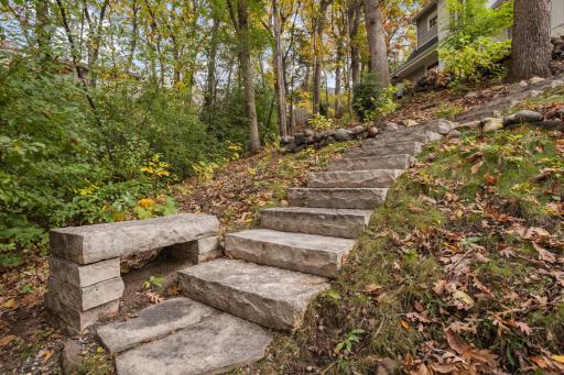 Stone steps through the back of the property, including a built in bench