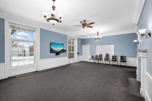 One of the two large ballrooms on the main level with decorative marble fireplace.