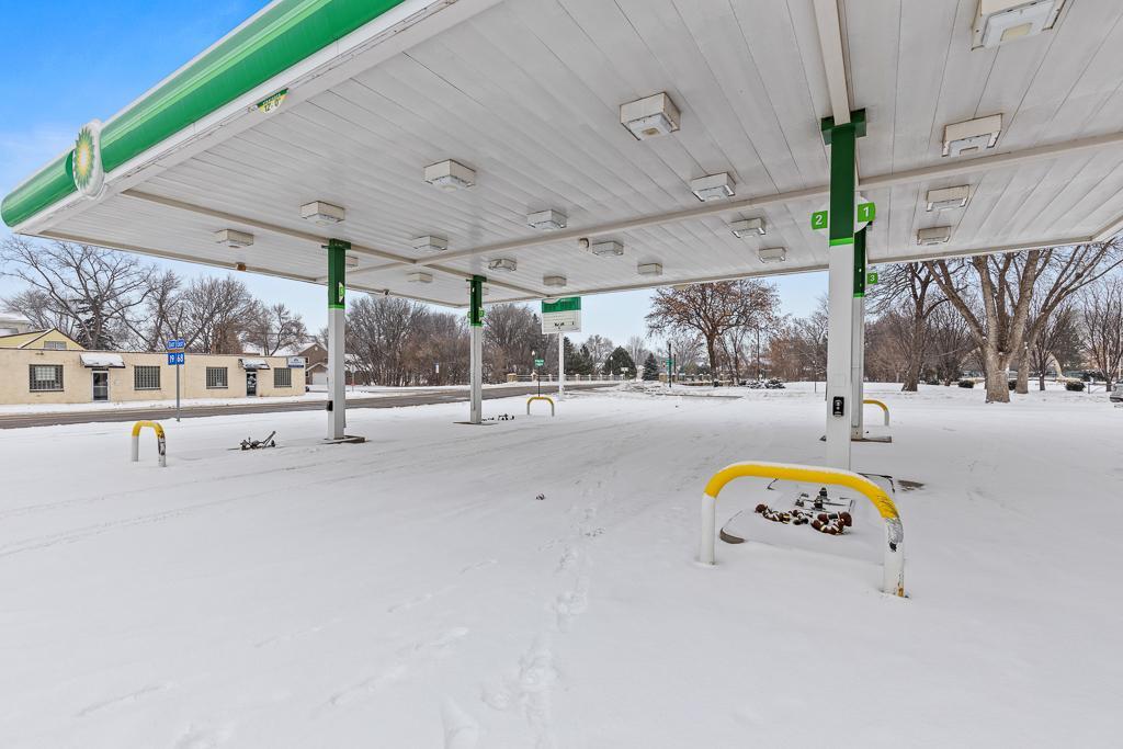 Well-lit canopy covering 4 pump areas with protective bollards for safety precautions